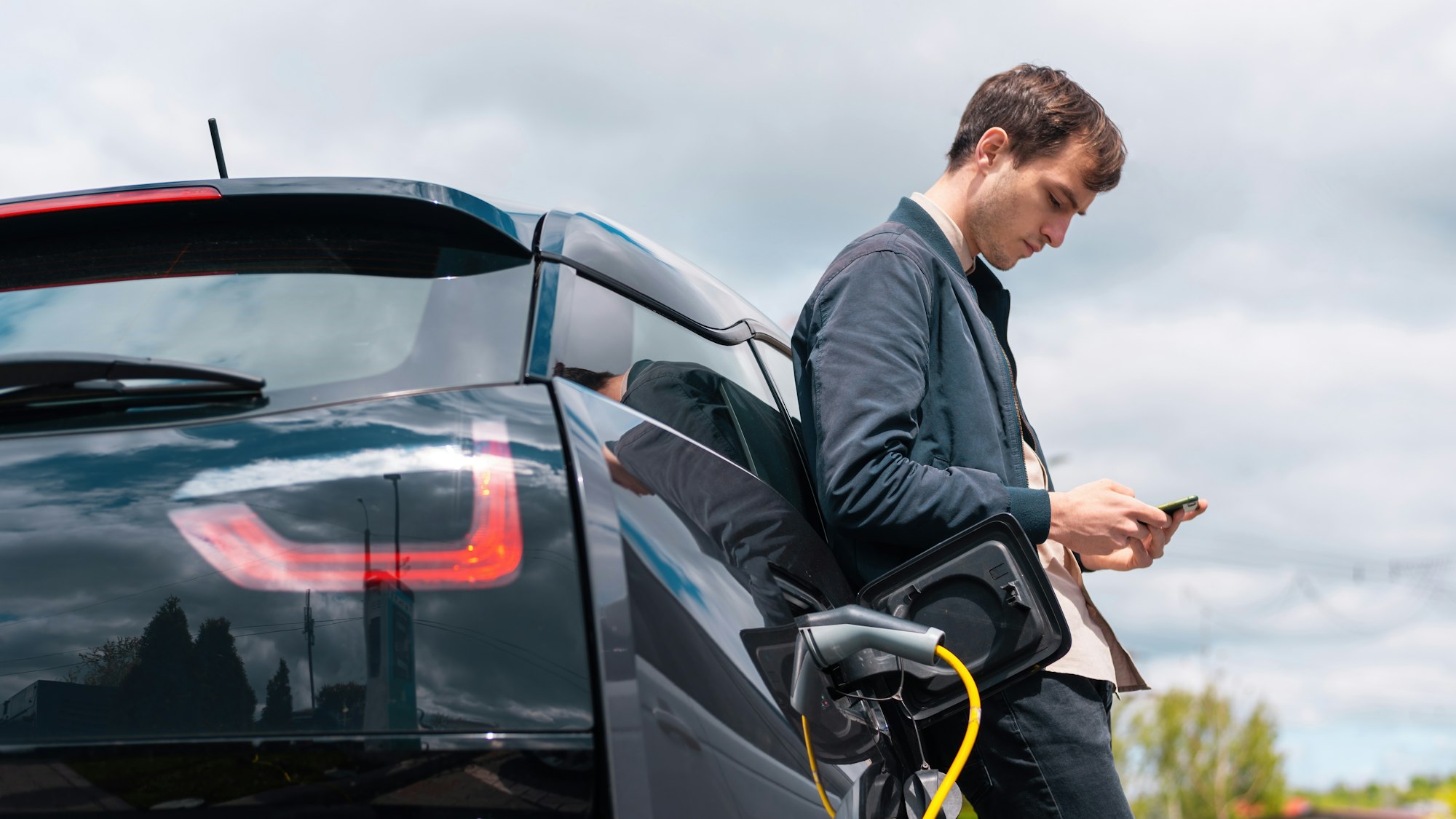 Man charging electric car